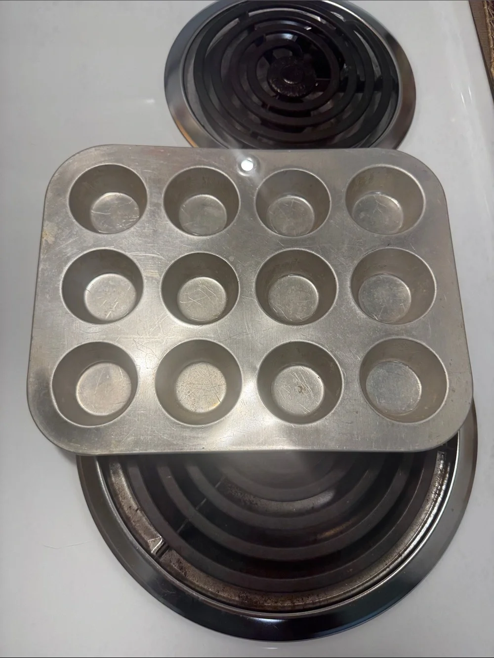 Two muffin pans, the large one is non-stick and NWOT. Small one is in GUC.